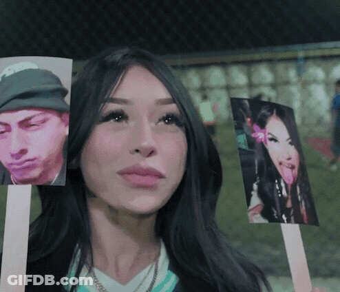 Woman Holding Pictures Of Man And Woman GIF