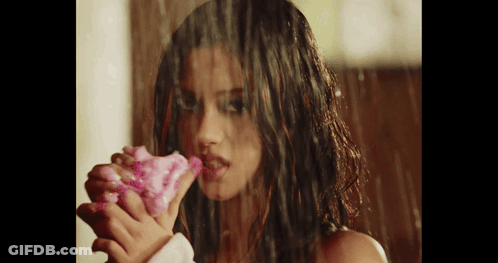 Woman Holding Pink Flower In Rain GIF