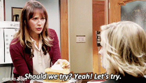 Woman Holding Plate Of Food Says Should We Try GIF