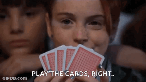 Woman Holding Playing Cards In Front Of Face GIF