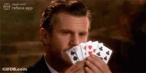 Woman Holding Playing Cards Over Face Ysee GIF