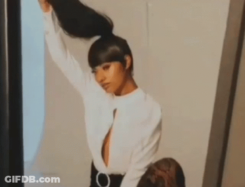Woman Holding Ponytail In Mirror GIF