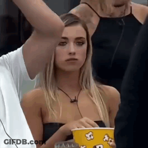 Woman Holding Popcorn Bucket Man Holds Her Arm GIF