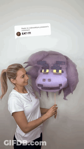 Woman Holding Purple Hippo Cotton Candy Saying Eat It GIF
