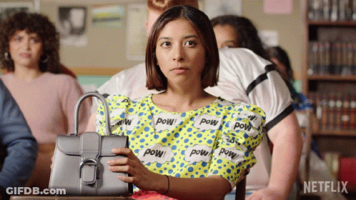 Woman Holding Purse In Front Of Netflix Logo GIF