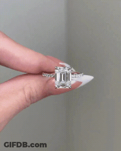 Woman Holding Ring With Large Diamond GIF