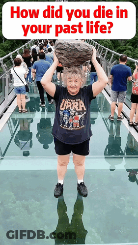 Woman Holding Rock Over Head In Ubra Shirt GIF
