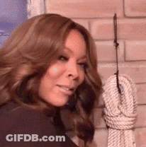 Woman Holding Rope At Brick Wall GIF