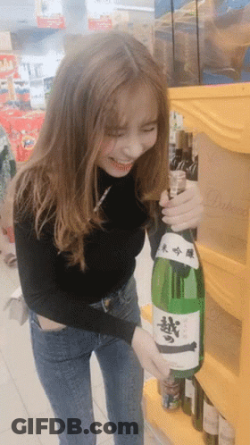 Woman Holding Sake Bottle With Chinese Characters GIF