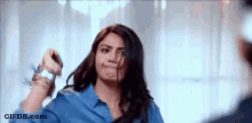 Woman Holding Scissors In Front Of Mirror GIF