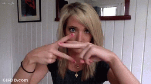 Woman Holding Scissors To Face GIF