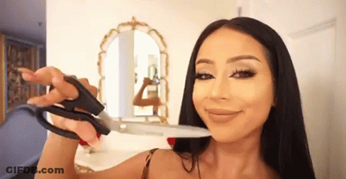 Woman Holding Scissors To Face GIF