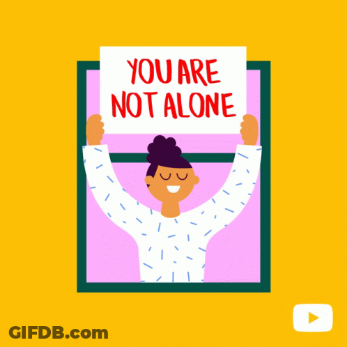 Woman Holding Sign Saying You Are Not Alone GIF