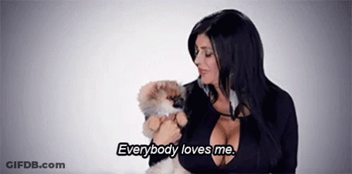 Woman Holding Small Dog Says Everybody Loves Me GIF