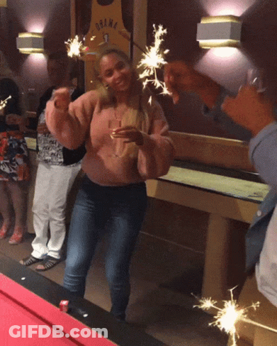 Woman Holding Sparklers In Front Of Obama Jersey GIF