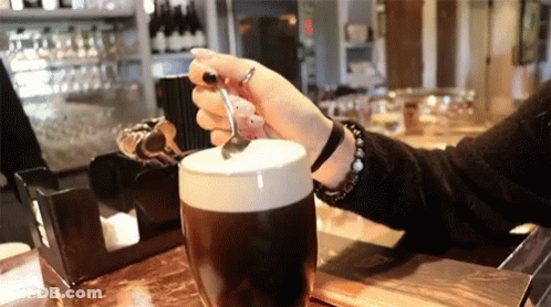 Woman Holding Spoon Over Coffee GIF