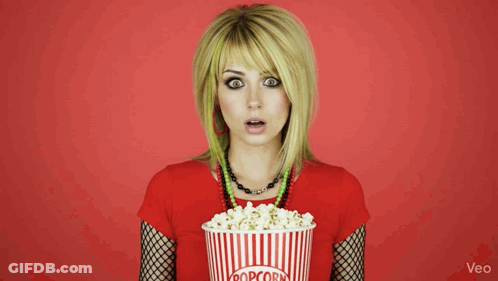Woman Holding Striped Bucket Of Popcorn GIF