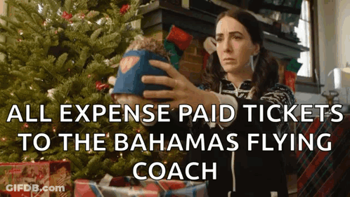 Woman Holding Stuffed Animal By Christmas Tree All Expense Paid Tickets To The Bahama GIF