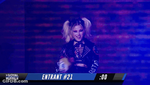 Woman Holding Stuffed Animal With Alexa Bliss On Screen GIF