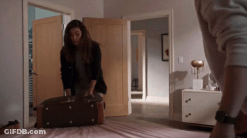 Woman Holding Suitcase In Bedroom GIF