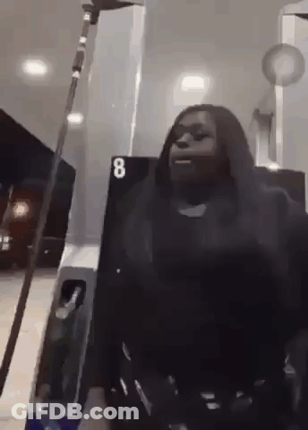 Woman Holding Sword At Gas Station GIF