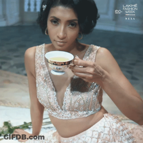 Woman Holding Tea At Lakme Fashion Week Nexa GIF
