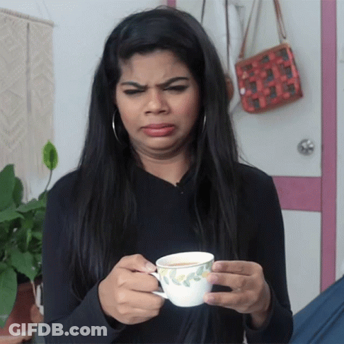 Woman Holding Tea Cup Making Funny Face GIF