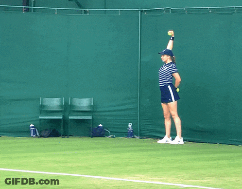 Woman Holding Tennis Ball Over Head On Court GIF