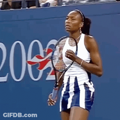 Woman Holding Tennis Racquet In Front Of Wall Number 2 GIF