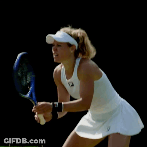Woman Holding Tennis Racquet In White Fila Top GIF