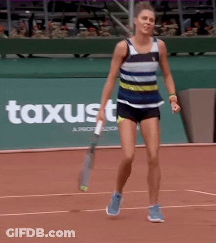 Woman Holding Tennis Racquet On Court With Axusto Sign GIF