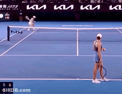 Woman Holding Tennis Racquet On Court With KTM Ad GIF