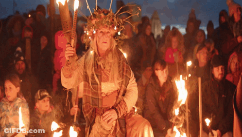 Woman Holding Torch In Crowd GIF