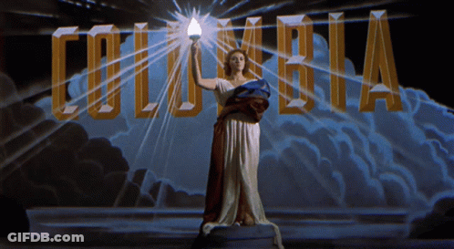 Woman Holding Torch In Front Of Columbia Logo GIF