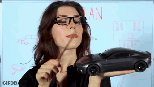 Woman Holding Toy Car In Front Of Whiteboard Saying Plan GIF