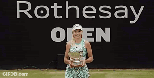 Woman Holding Trophy In Front Of Rothesay Open Banner GIF