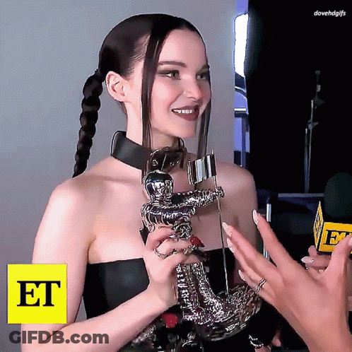Woman Holding Trophy With Word Et GIF