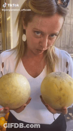 Woman Holding Two Cantaloupes With TikTok Logo GIF