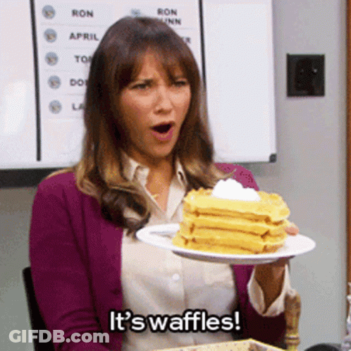 Woman Holding Waffles With Whipped Cream GIF