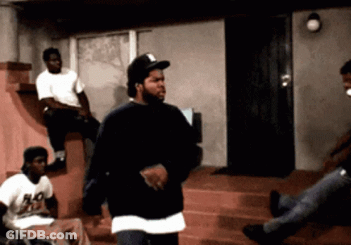 Woman Holding Wand At Window, Man In Background GIF