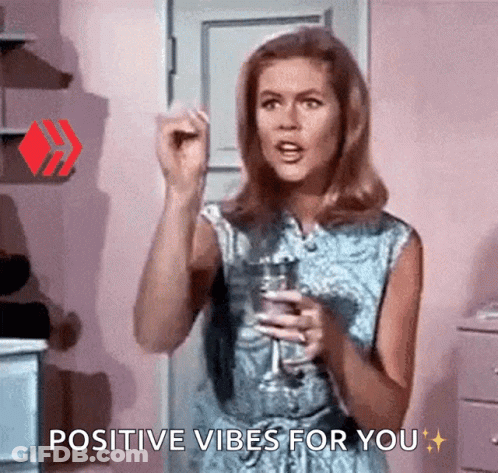 Woman Holding Wine Glass Saying Positive Vibes GIF