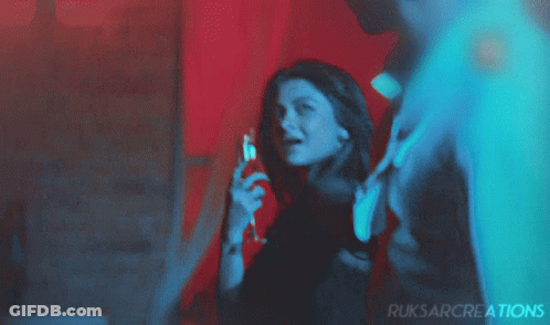 Woman Holding Wine In Front Of Ruksarcreations Sign GIF
