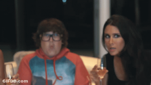 Woman Holding Wine Next To Boy With Glasses GIF