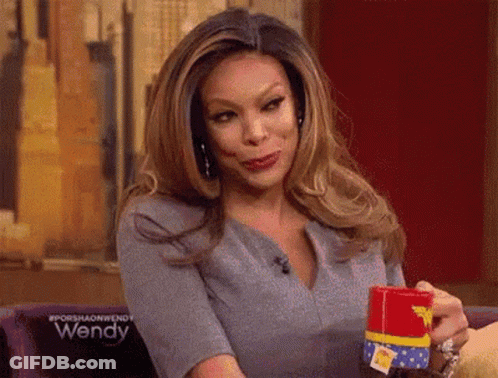 Woman Holding Wonder Woman Cup With Funny Face GIF