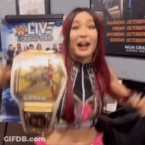 Woman Holding Wrestling Championship Belt At W Live Holiday Tour GIF