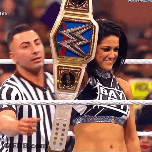 Woman Holding Wrestling Championship Belt With Bay On Top GIF