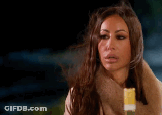 Woman Holding Yellow Popsicle Making Funny Face GIF