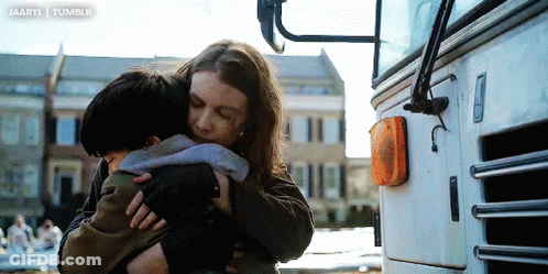 Woman Hugging Child In Front Of Bus GIF