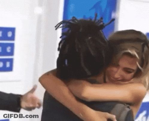 Woman Hugging Dreadlocked Man Giving Thumbs Up GIF