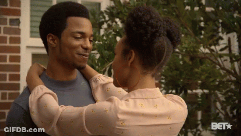 Woman Hugging Man At Brick Building With BET Logo GIF